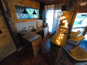 a kitchen with a counter and a sink in a room at Buļļi atpūtas vieta in Gūžas +12 photos