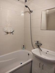 a bathroom with a tub and a sink and a shower at чудова охайна квартира in Sumy