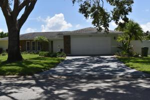 a house with a tree and a driveway at Emerald House in Bradenton
