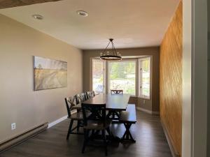 a dining room with a table and chairs at Stunning 4 BR Home Mountain Views Tranquil Setting in Breckenridge