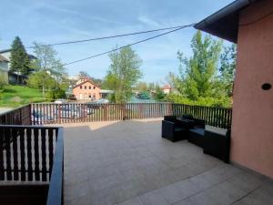 a balcony with a bench and a fence at Riverside Panorama Apartment 1 near City Center Brko 1 in Banja Luka