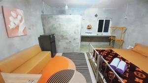 a room with a bed and a couch and a table at Neena S House in Koh Phangan