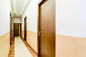 a corridor of a hospital hallway with wooden doors at Hotel O MD INTERNATIONAL GUEST HOUSE in Kolkata