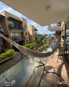 a hammock on the balcony of a building at Alojamiento Familiar para 21 - A 5min del Aeropuerto - Con 4 Pisincas - 3 Jacuzzi - By Molca Travel in Armenia