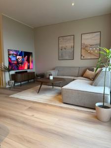 a living room with a couch and a table at Modern house at Senja in Silsand