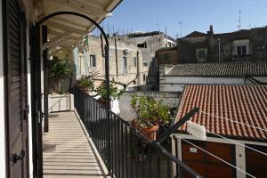 a balcony of a building with potted plants on it at Nei pressi dei Sassi in Matera