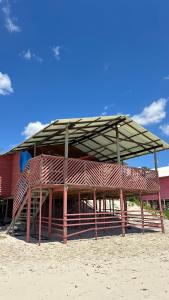 a large building with a roof on the beach at Brisa do Mar in Macajatuba +2 photos
