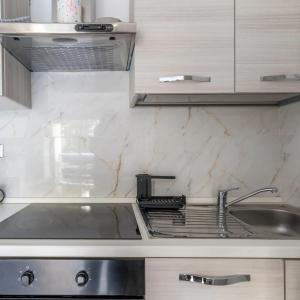 a kitchen with a sink and a counter top at Casa Dolce Vita Menton in Menton +63 photos