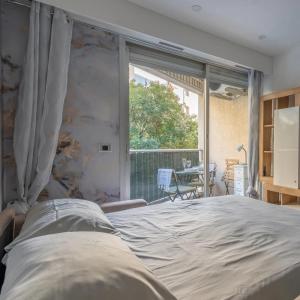 a bedroom with a large bed and a window at Casa Dolce Vita Menton in Menton