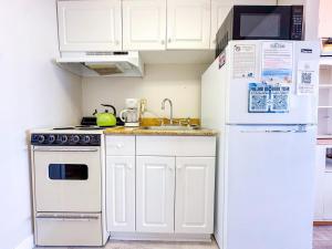 a kitchen with white cabinets and a white refrigerator at Grand Strand Resort II 18 in North Myrtle Beach