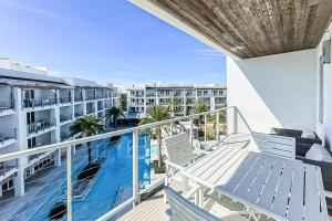 a balcony with a view of a swimming pool at The Pointe 3-341 in Inlet Beach
