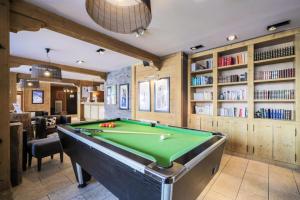 a pool table in a room with book shelves at Résidence Les Crêts - maeva Home - 3 Pièces 6 Personnes - Confort MAE-1026 in Les Allues +12 photos