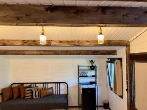 two lights hanging above a bed in a room at Baltic Beach Charm Tiny House C in Pērkone