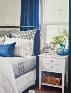 a bedroom with a bed with a nightstand next to a window at Rural Villa Guesthouse in Naledi