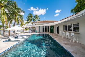 a swimming pool in the backyard of a villa at Luxury Channel Villa, Boat Dock and Private Pool, 5BR in Fort Lauderdale