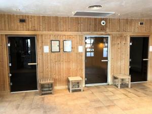 a lobby with wooden walls and doors and two benches at Résidence Les Arcs 1950 Le Village - maeva Home - Appartement 3 pièces 6 personnes vue sur le Mont Blanc - Prestige - super Home MAE-4490 in Bourg-Saint-Maurice +32 photos