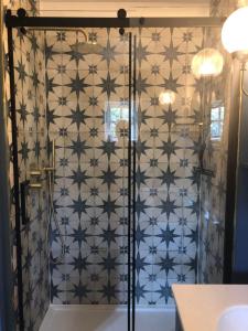 a shower in a bathroom with a tiled wall at Cabin in the hills near Dolgellau in Dolgellau +24 photos