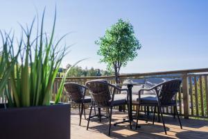 a patio with a table and chairs on a deck at Honne Hotell in Biri