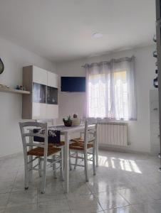 a kitchen with a table and chairs in a room at Casetta Trionfale in Rome