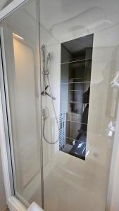 a bathroom with a shower with a mirror at Watt-Fee in Westerland +21 photos