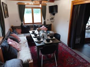a living room with a table and a couch at Chata Bory in Klenovice