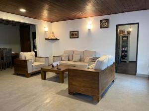 a living room with a couch and a coffee table at Andras Eden in Hatton