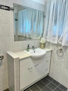 a bathroom with a sink and a mirror at Cosy Room in North Ryde #2 in Sydney