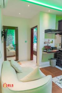 a living room with a white couch in a room at Residence Le Sommet in Douala