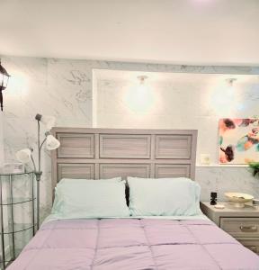 a bedroom with a large bed with pink sheets at Vessel Hotel Studio Suite of Atlanta in Atlanta