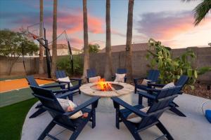 a patio with a table and chairs and a fire pit at Sleeps 16 Pool Hot Tub Sport Court Game Room in Peoria