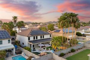 an aerial view of a house with a pool and palm trees at Sleeps 16 Pool Hot Tub Sport Court Game Room in Peoria