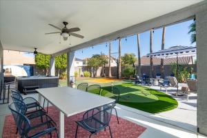 a patio with a table and chairs and a tennis court at Sleeps 16 Pool Hot Tub Sport Court Game Room in Peoria