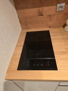 a stove top oven sitting on top of a wooden counter at Appartement 1 chambre in Longevilles-Mont-dʼOr