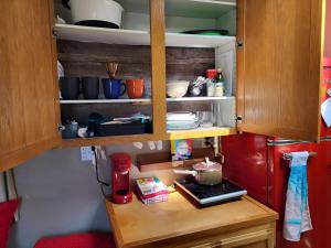a kitchen with wooden cabinets and a table with dishes at Caravan Across The Street From The Beach in Blaine +25 photos