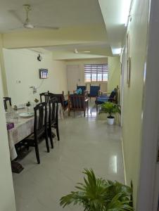 a dining room with a table and chairs at Ocean Park Haven Apartments in Kannur +5 photos