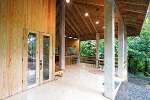 an open porch of a house with a wooden ceiling at Indómito Chalet-El Yunque Zone in Juncos
