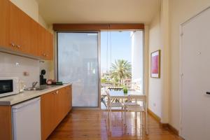 a kitchen with a table and chairs and a large window at Central Penthouse Sky Suite in Nicosia
