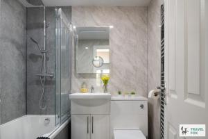 a bathroom with a sink and a shower and a toilet at Angel Cottage - 5 mins drive to Alton Towers! in Alton +58 photos