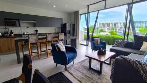 a living room with a kitchen and a living room at "Modern Style in Mezcales: Minutes from the Beach" in Mezcales