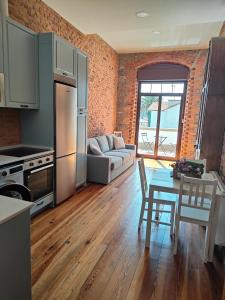 a kitchen and living room with a table and a couch at 2- Atardeceres in Castro-Urdiales +18 photos