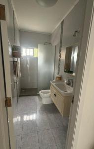 a bathroom with a toilet and a sink and a shower at Relax1 in Paysandú