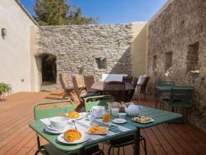 a table with plates of food on a patio at Domaine des Périès - Chambres d'hôtes in Saint-Martin-Lalande