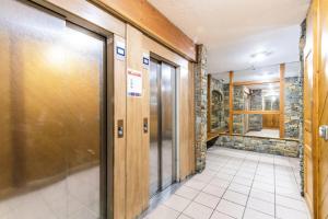 a hallway of a building with a stone wall at Résidence Arcelle - VAL THORENS location: studio cabine en plein centre de la station MAE-9104 in Val Thorens +17 photos