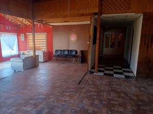 a living room with a couch and a table at Casa Taberna Azul in Vallenar +3 photos