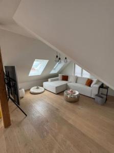 a living room with a white couch and a table at Tolle Wohnung mit Seeblick! in Rorschach