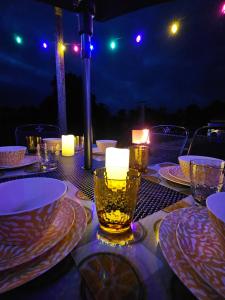 a table with plates and candles on top of it at Red Robin Cottage in Castlewellan