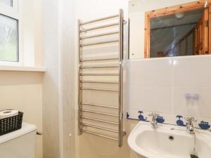 a bathroom with a sink and a mirror at Hembry Meadows in Callington +7 photos