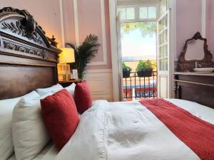 a bedroom with a large bed with red and white pillows at Casa Turin in Mexico City