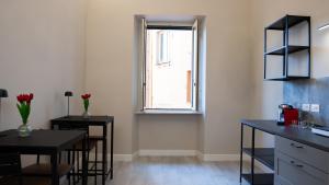 a kitchen with a table and chairs and a window at Suites 215 Colosseum - Guesthouse in Rome