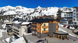 an aerial view of a resort with snow covered mountains at Smarthotel inAlpe in Obertauern